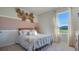 Charming bedroom featuring a full bed, a window with curtains, and decorative wall accents at 198 Amberwood Way, Umatilla, FL 32784
