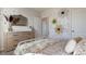 bedroom featuring a full bed, a dresser with mirror, and decorative flower wall decals at 198 Amberwood Way, Umatilla, FL 32784