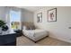 Small bedroom with a full bed, black night stand, art on the wall, and a window with a view at 198 Amberwood Way, Umatilla, FL 32784