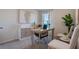 Home office with a modern desk, stylish cabinet, neutral tones, and natural light from the window at 198 Amberwood Way, Umatilla, FL 32784
