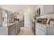 Bright kitchen featuring gray cabinets, stainless steel appliances, granite countertops, and an island with a sink at 198 Amberwood Way, Umatilla, FL 32784