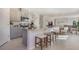 Modern kitchen with gray cabinets, granite countertops, stainless steel appliances, and an island with seating at 198 Amberwood Way, Umatilla, FL 32784