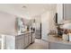 Well-lit kitchen featuring gray cabinets, stainless steel appliances, granite countertops, and a center island at 198 Amberwood Way, Umatilla, FL 32784