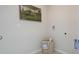 Bright laundry area with neutral walls and stylish decor and a lovely painting adding a touch of elegance at 198 Amberwood Way, Umatilla, FL 32784
