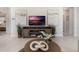 Comfortable living room with a stylish entertainment center, modern decor, and neutral colors at 198 Amberwood Way, Umatilla, FL 32784
