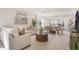 Open-concept living space with dining area, a comfortable sofa, and modern decor throughout at 198 Amberwood Way, Umatilla, FL 32784