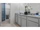 Bathroom with a granite countertop, double sinks, gray cabinets, and a walk-in shower at 2052 Monteverde Ave, Davenport, FL 33837