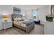 Well-lit bedroom featuring a cozy bed with decorative pillows and modern lamps at 2052 Monteverde Ave, Davenport, FL 33837