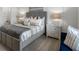 Bedroom with a stylish bed with neutral bedding, side tables, and soft lighting at 2052 Monteverde Ave, Davenport, FL 33837