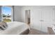 Bright bedroom showcasing a plush bed, view to outside, and a closet with double doors at 2052 Monteverde Ave, Davenport, FL 33837
