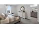 Comfortable bedroom featuring neutral tones, a stylish dresser, and a view into the bathroom at 2052 Monteverde Ave, Davenport, FL 33837