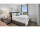 Comfortable bedroom featuring white bedding, modern decorations, and a view to the outside at 2052 Monteverde Ave, Davenport, FL 33837