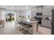 Open kitchen featuring an island with seating, modern appliances, and sliding glass doors at 2052 Monteverde Ave, Davenport, FL 33837