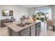 Modern kitchen island with granite countertops and a stainless steel sink at 2052 Monteverde Ave, Davenport, FL 33837