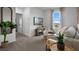 Serene living room featuring a plush sofa, stylish decor, and a view of greenery from the window at 2052 Monteverde Ave, Davenport, FL 33837