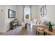 Cozy living room with a comfortable sofa, decorative pillows, and a view of lush greenery outside the window at 2052 Monteverde Ave, Davenport, FL 33837