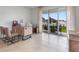 Bright home office with sliding glass doors to the backyard, and two chairs at 2052 Monteverde Ave, Davenport, FL 33837