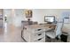 Home office with a large desk, neutral decor, and tiled floors at 2052 Monteverde Ave, Davenport, FL 33837