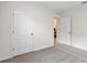 Neutral-toned bedroom showcasing neutral walls and carpet and doors to the bathroom and closet at 207 Taylor Groves Dr, Lake Wales, FL 33898