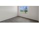 Bright bedroom featuring plush carpet and a large window overlooking a quiet street at 207 Taylor Groves Dr, Lake Wales, FL 33898