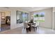 Bright dining room showcasing a glass-top table, chic seating, and modern accents, with a view into the bedroom at 207 Taylor Groves Dr, Lake Wales, FL 33898