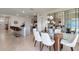 Spacious area with a kitchen island, bar seating, a glass dining table, and modern décor at 207 Taylor Groves Dr, Lake Wales, FL 33898