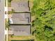 Aerial view of houses with brown roofs nestled amidst lush greenery, offering a serene and private setting at 2127 Bay Line Rd, Oakland, FL 34787