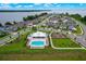 Aerial view of a lakeside community featuring a pool, playground, and picturesque surroundings at 2127 Bay Line Rd, Oakland, FL 34787