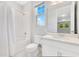 Bathroom featuring tub, shower, a large mirror, vanity with sink, toilet and all-white modern look at 2127 Bay Line Rd, Oakland, FL 34787
