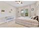 Cozy bedroom with a queen-sized bed, ceiling fan, and view to lush trees through two windows at 2127 Bay Line Rd, Oakland, FL 34787