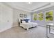 Bright bedroom features large windows, a tray ceiling, and neutral decor at 2127 Bay Line Rd, Oakland, FL 34787