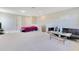 Open bonus room featuring plush carpet, a modern entertainment setup, and sitting area at 2127 Bay Line Rd, Oakland, FL 34787