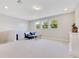 Bonus Room featuring three bright windows, a ceiling light, and neutral colored walls and carpet at 2127 Bay Line Rd, Oakland, FL 34787