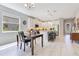 Open kitchen featuring a dining area, a center island with seating, and stainless steel appliances at 2127 Bay Line Rd, Oakland, FL 34787