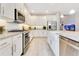 Modern kitchen featuring granite countertops, stainless steel appliances, and bright white cabinetry at 2127 Bay Line Rd, Oakland, FL 34787