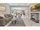 Open-concept living space flows into kitchen, featuring modern fireplace and comfortable seating at 2127 Bay Line Rd, Oakland, FL 34787