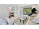 Bright living room featuring a fireplace, TV, piano, and sliding glass doors to outdoor patio at 2127 Bay Line Rd, Oakland, FL 34787