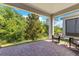 Covered patio with brick flooring and a view of the private, lush green backyard, perfect for outdoor relaxation at 2127 Bay Line Rd, Oakland, FL 34787