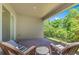 Relaxing covered patio with brick flooring and comfortable wicker seating, perfect for enjoying the outdoors at 2127 Bay Line Rd, Oakland, FL 34787