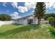 This backyard features a well-maintained lawn, mature trees, and a fenced perimeter for privacy at 2164 Rj Cir, Kissimmee, FL 34744