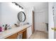 Functional bathroom includes a vanity with sink, mirror and linen storage space at 2164 Rj Cir, Kissimmee, FL 34744