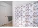 Clean bathroom features a shower/tub combo with patterned curtain and tiled floor at 2164 Rj Cir, Kissimmee, FL 34744