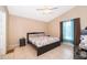 Comfortable bedroom with tile flooring and ample natural light creates a serene atmosphere at 2164 Rj Cir, Kissimmee, FL 34744
