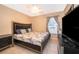 Cozy bedroom features a large bed, side table, and window with natural light at 2164 Rj Cir, Kissimmee, FL 34744