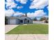 Charming single-story home featuring a well-maintained lawn and a white picket fence at 2164 Rj Cir, Kissimmee, FL 34744