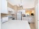 Well-lit kitchen equipped with quartz countertops and white appliances; plenty of storage at 2164 Rj Cir, Kissimmee, FL 34744
