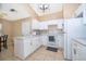 Open kitchen with ample counter space, white cabinets, and modern lighting fixtures at 2164 Rj Cir, Kissimmee, FL 34744