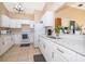 Bright kitchen featuring white cabinetry, quartz countertops, and stainless steel appliances at 2164 Rj Cir, Kissimmee, FL 34744