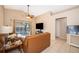 Bright living room boasts neutral tile floors, vaulted ceiling and sliding doors to a screened porch at 2164 Rj Cir, Kissimmee, FL 34744