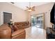 Spacious living room with tile floors, vaulted ceiling, and sliding doors to a screened patio area at 2164 Rj Cir, Kissimmee, FL 34744